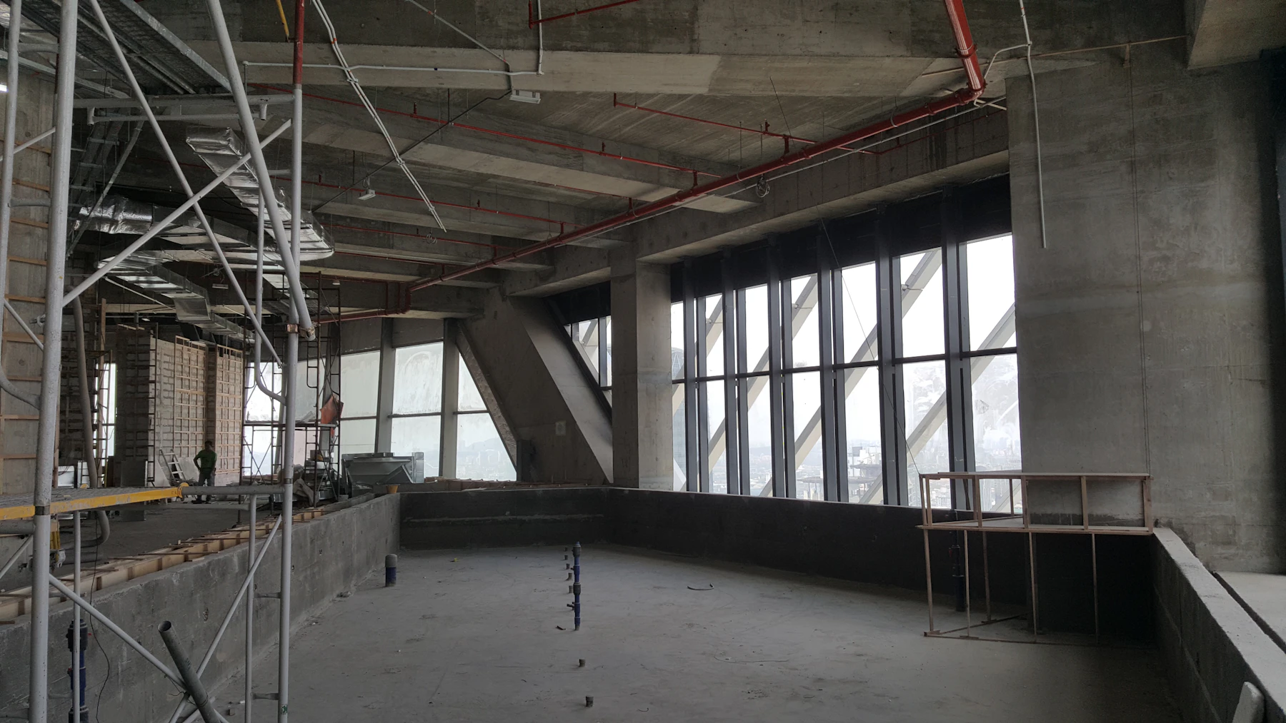 Concrete columns, glazing, and services coming together inside a commercial building