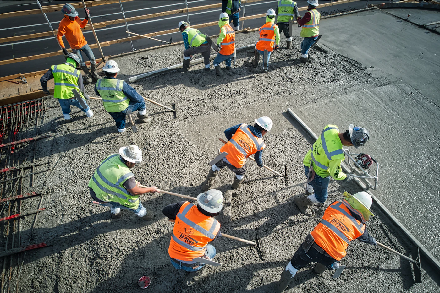 A crew coordinating concrete placement and finishing on an elevated slab